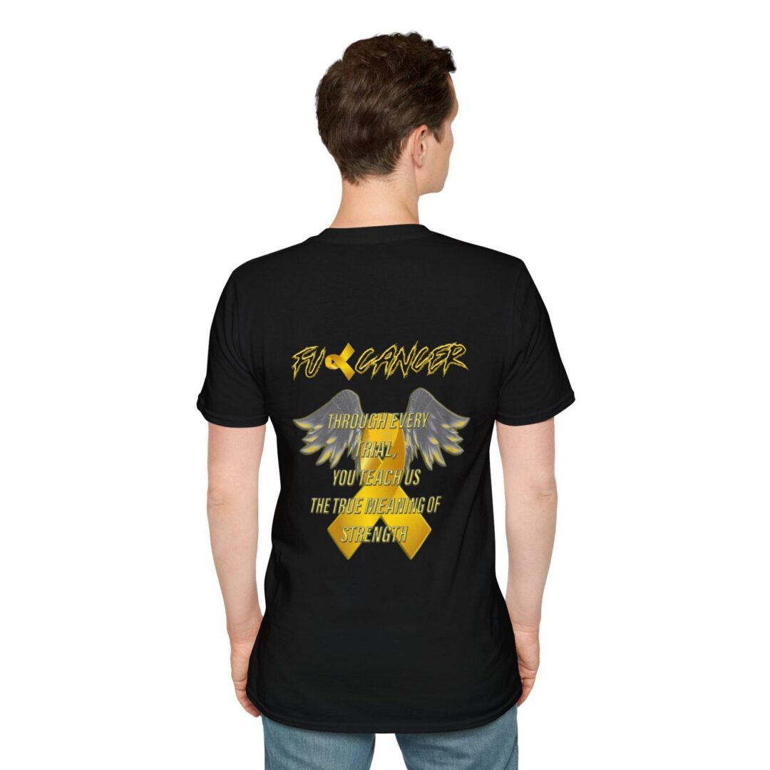 A person faces away, wearing the FU Cancer Childhood Cancer Awareness Tee—a black shirt with "FU CANCER" in yellow, an awareness ribbon with wings, and “Through every fight, you teach us the true meaning of strength.”.