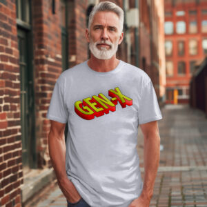 A man with gray hair and a beard stands outside near brick buildings, wearing the Gen-X Vintage Tee—a light gray shirt with bold, colorful "GEN-X" lettering.