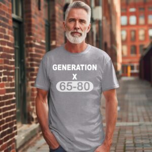 A gray-haired, bearded man stands outside wearing the Retro Generation X Gym Tee, a gray shirt with "GENERATION X 65-80" printed in white.